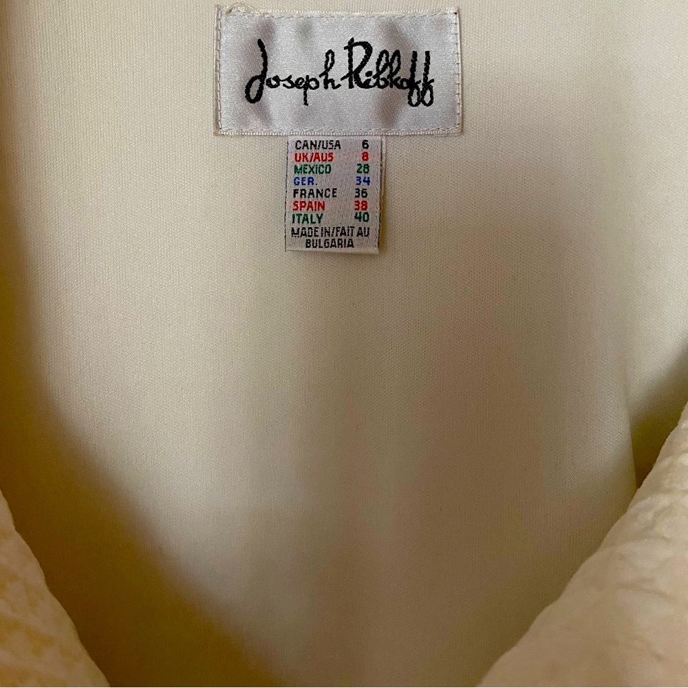 Knee length spring coat.  Never worn.  White size 6-8.